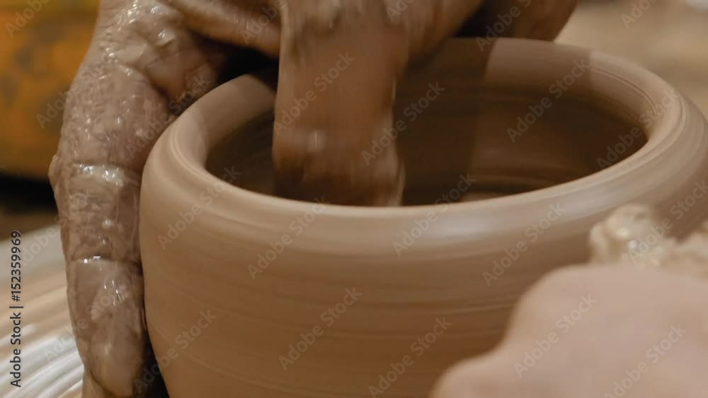 Potter is making clay pot bowl or vase ceramics porcelain on the potter's wheel. Creating pottery art and handicraft modelling creation. Potter is making clay pot bowl or vase ceramics porcelain on the potter's wheel. Creating pottery art and handicraft modelling creation.