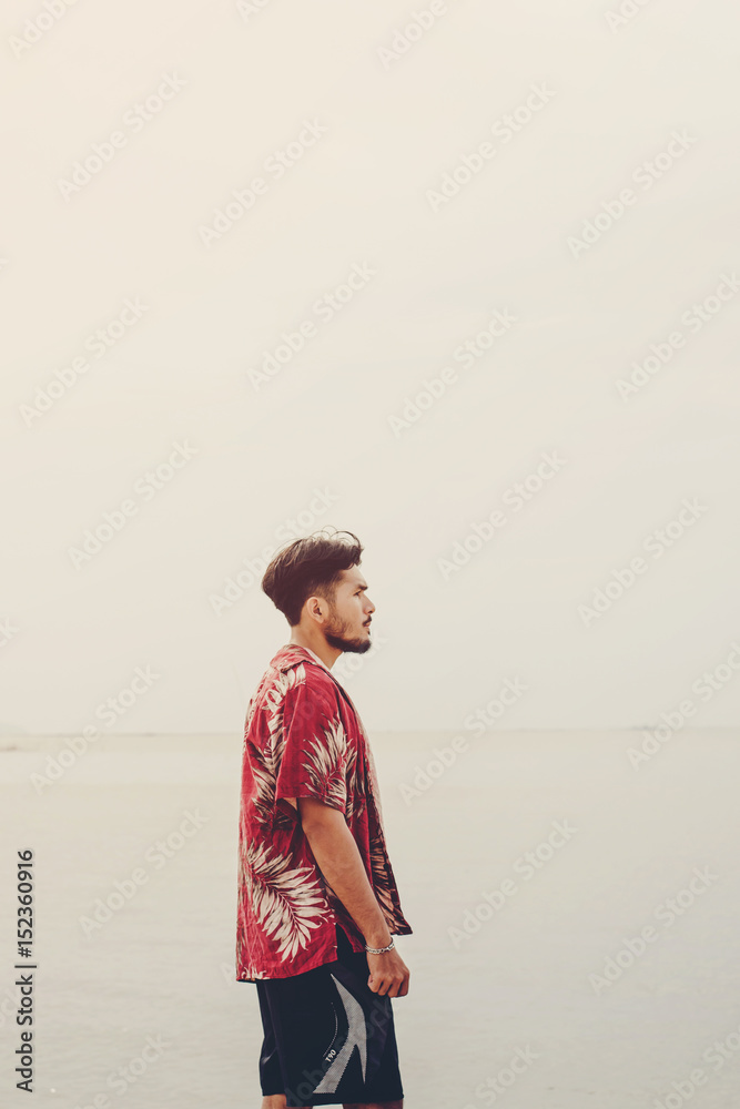 Young man looking for something on the beach. Young man looking for something on the beach.