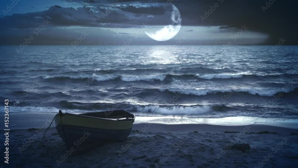 Lonely boat at night with a beautiful big waxing moon above the sea.