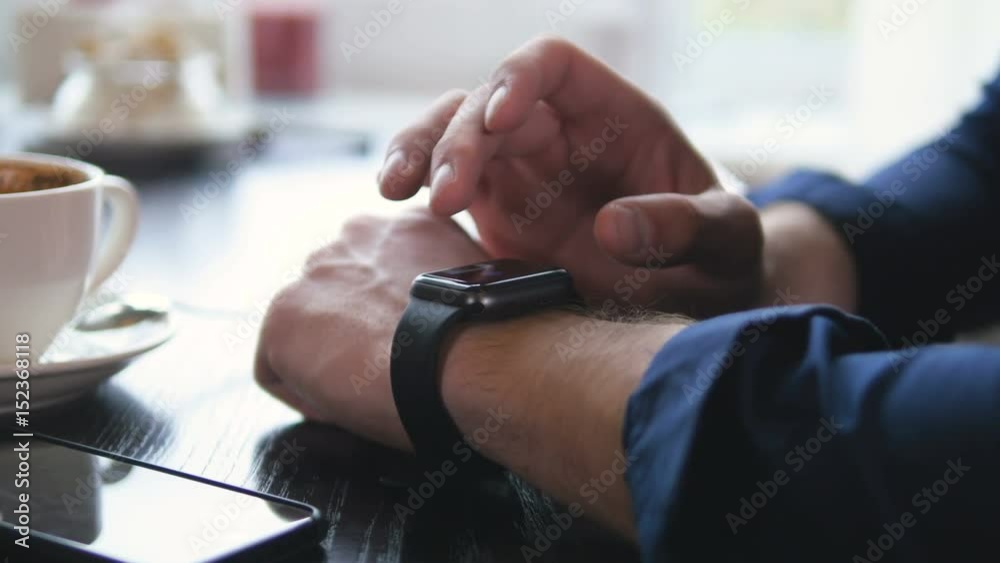 Modern smartwatch used on a mans hand. Hi-tech device concept. 4K.