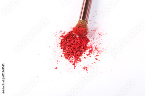 Makeup brush background with blush sprinkled on white