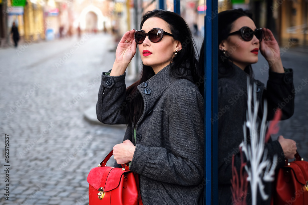Obraz premium Woman on the street with red backpack