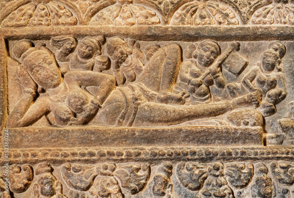 Massage for the Indian goddess on stone patterned relief of 7th century temple in Pattadakal, India. UNESCO World Heritage site with carved temples