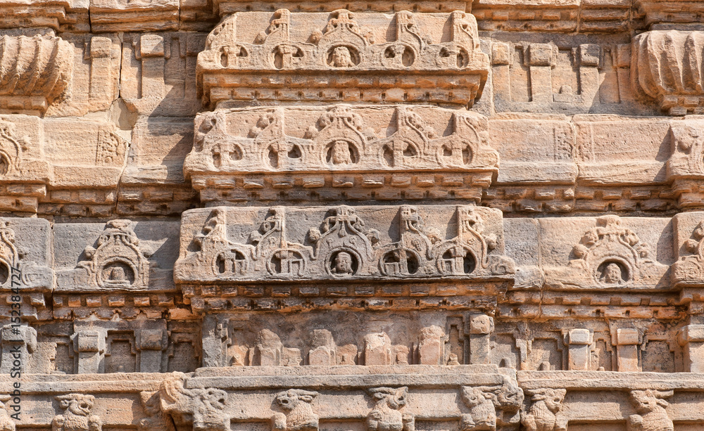 Ancient design of stone relief on wall of 7th century temple in Pattadakal of Karnataka, India. UNESCO World Heritage site with stone carved temples