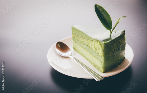 Wallpaper Mural Close up Green tea cake on white disk with matcha green tea on the black wooden, sweet food of dessert Green tea cake. background space for texture. Torontodigital.ca