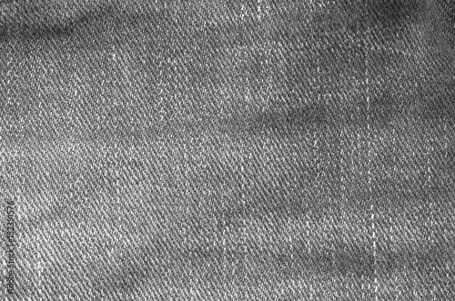 Closeup surface of old jean trousers fabric textured background in black and white tone