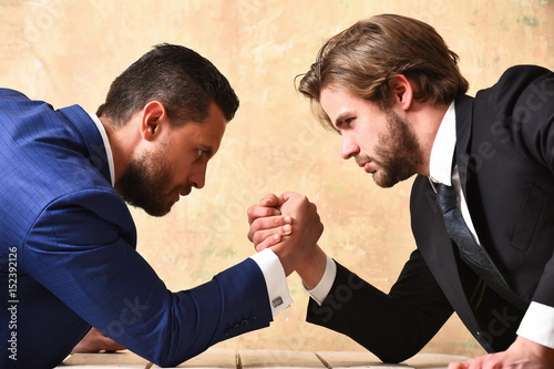 arm wrestling of businessman and compete man photo