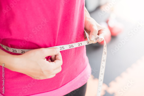 Close up of woman with measuring tape