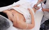 Beautiful girl in a beauty salon on a vacuum massage procedure. Hardware cosmetology. Cellulite, youth, fat, overweight