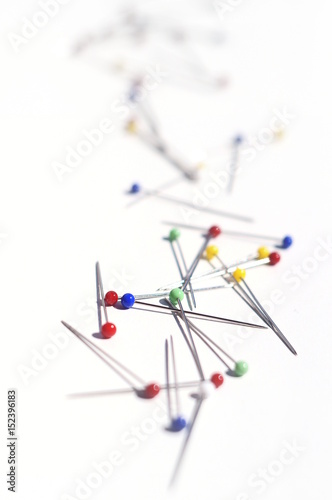 colorful pins on white background - upright format