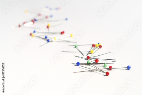 colorful pins on white background - horizontal format
