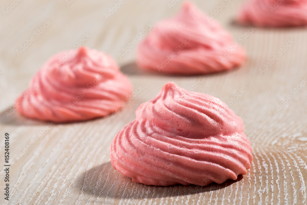 Colorful pink meringue on wood Colorful pink meringue on wood