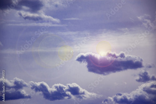 Abstract landscape of blue sky in the light of the sun behind the clouds
