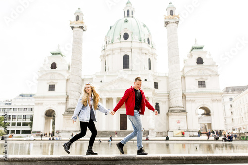 Young couple walking holdin...