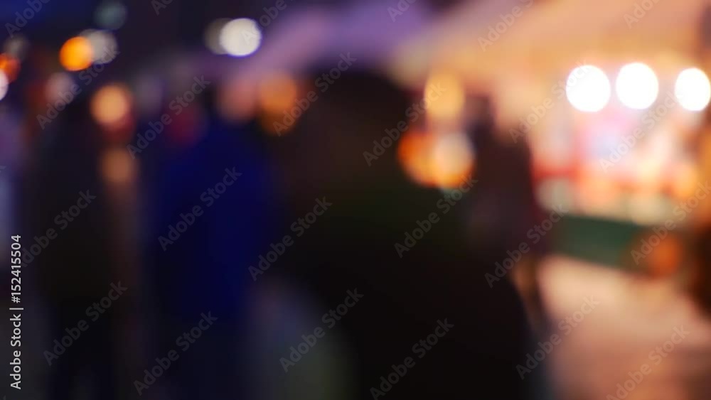a Busy Street in the Evening City With Car Headlights and Dark Silhouettes People Blurred Background of Brightly Colored Lighting. Out Focus, Blurry a Busy Street in the Evening City With Car Headlights and Dark Silhouettes People Blurred Background of Brightly Colored Lighting. Out Focus, Blurry