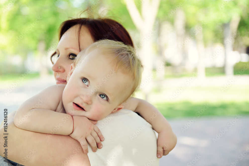 Happy mother holding her adorable little son. Family outdoor leisure. Little kid with his mom playing in park. Happy mother holding her adorable little son. Family outdoor leisure. Little kid with his mom playing in park.