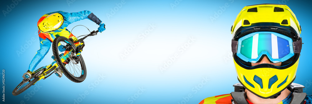 Fototapeta premium wide panorama of extrem whip jump on mountain bike and biker potrait on blue background downhill freeride enduro concept