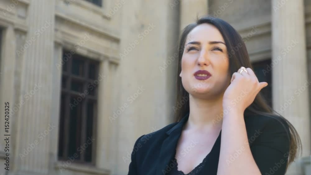 Closeup view of young happy girl talking and laughing in the city