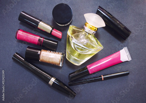 Decorative cosmetics isolated on dark background. Different makeup products. Close up