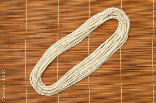 Folded rope, on a wooden background