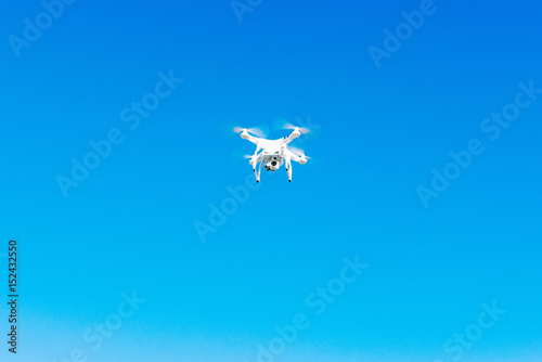 Uav drone copter flying with digital camera. Hexacopter drone with high resolution digital camera on the sky.