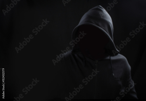 Unknown person concept.Hooded silhouette on black, with no face