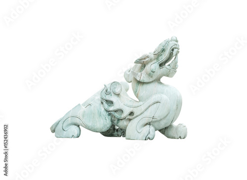 Closeup old green jade leo statue for good fortune in front of door in the temple of thailand isolated on white background with clipping path
