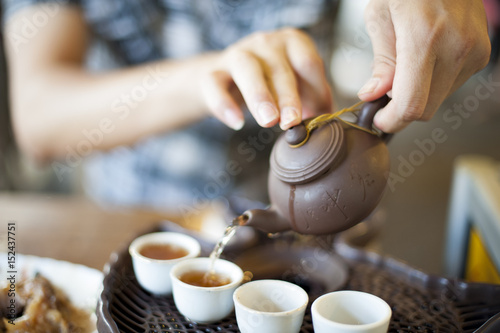 A young man is preparing some hot tea to start his day.