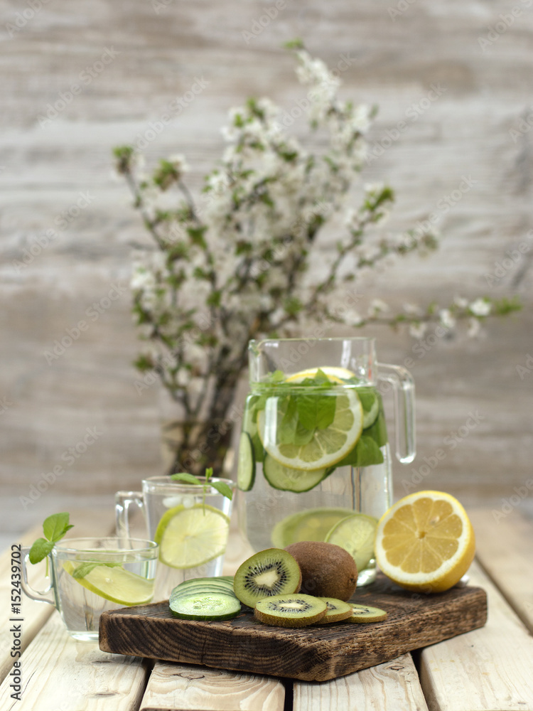 refreshing drink with lemon on a wooden board. refreshing drink with lemon on a wooden board.