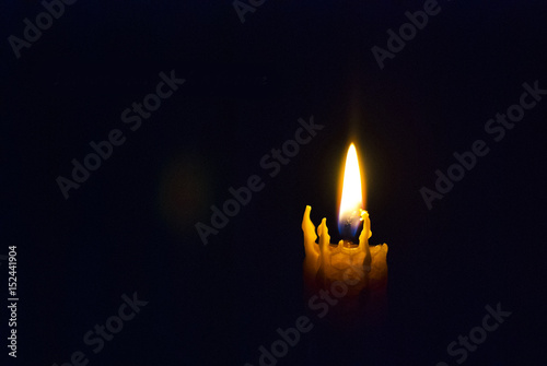 The candle burns in the dark