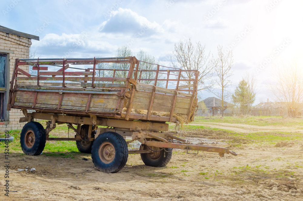Fototapeta premium Old trailer with wooden beehives in the countryside.