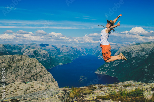 The happy tourist is jumping. Norway. Background.