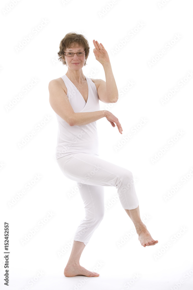 Mature woman practicing yoga exercise.