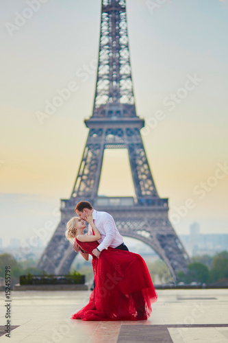 Couple kissing in front of the Eiffel tower in Paris, France © Ekaterina Pokrovsky