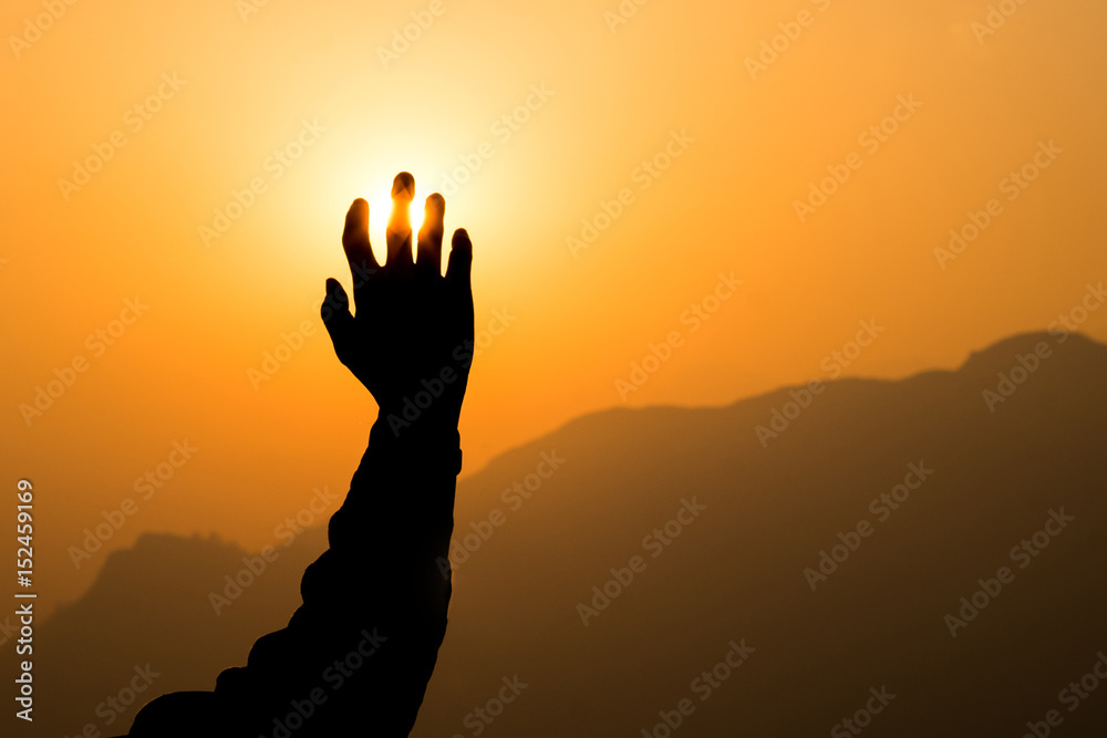 Right hand reaching golden sun