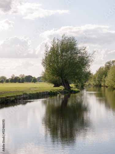 a riverside open scene outside in the country in essex england uk with no people and o boats, very lush and pretty on a late summer's afternoon