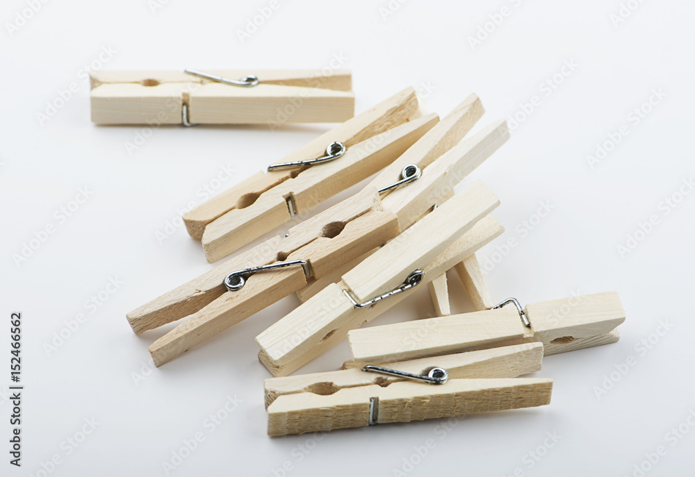 Wooden clothespin stacked on white background. Isolated. Wooden clothespin stacked on white background. Isolated.