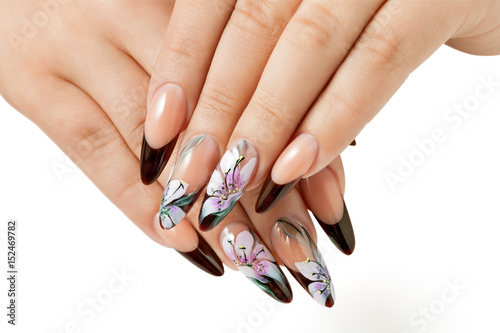 Nail art service. Female manicure and floral patterns.
