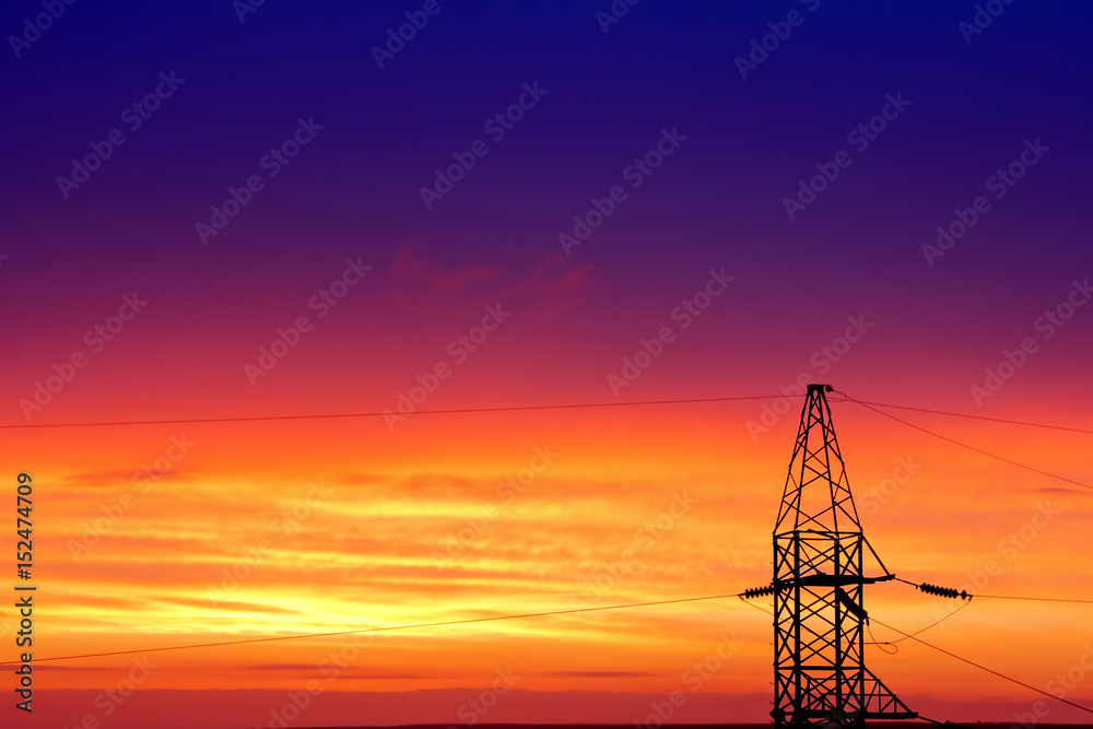 Electric Power Transmission Lines and Electricity Tower at Sunset.