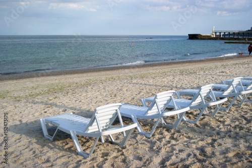  Sunbeds on the beach, a place for sunbathing. Sea summer © Vita