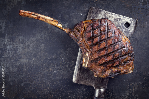Barbecue dry aged Wagyu Tomahawk Steak as close-up on old metal sheet photo