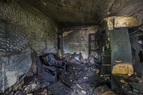Interior of a burnt by fire apartment in an apartment building, burned furniture 