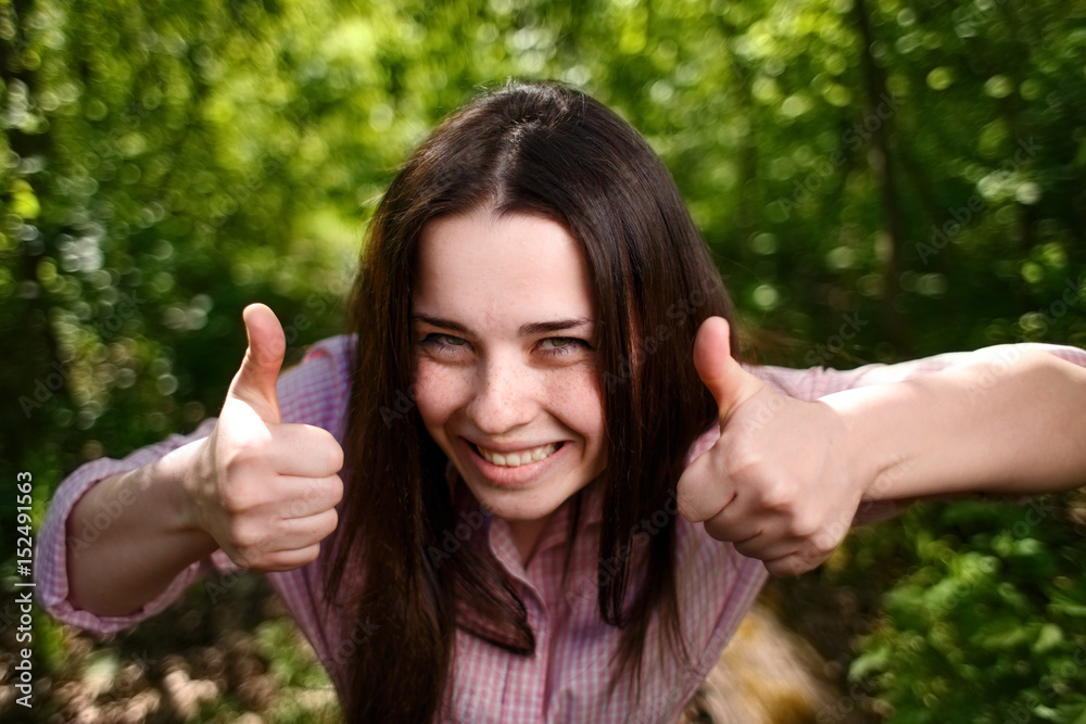 Portrait of young excited woman with thumbs up Portrait of young excited woman with thumbs up