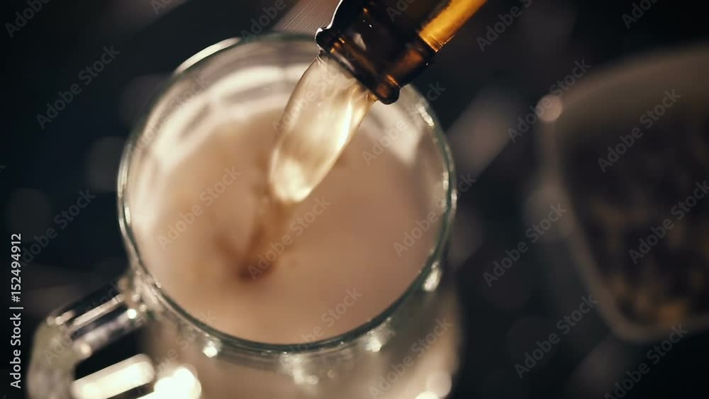 Closeup shot of Pouring beer into mug. Top view Closeup shot of Pouring beer into mug. Top view