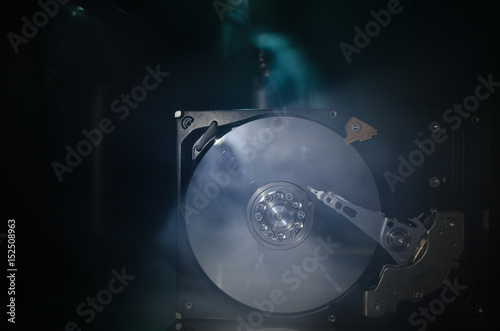 Adjustable wrench turn off a hard disk. On a dark background. Computer repair concept
