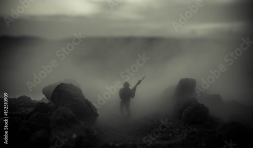 War Concept. Military silhouettes fighting scene on war fog sky background, World War Soldiers Silhouettes Below Cloudy Skyline At night. Attack scene. Armored vehicles. Tanks battle photo