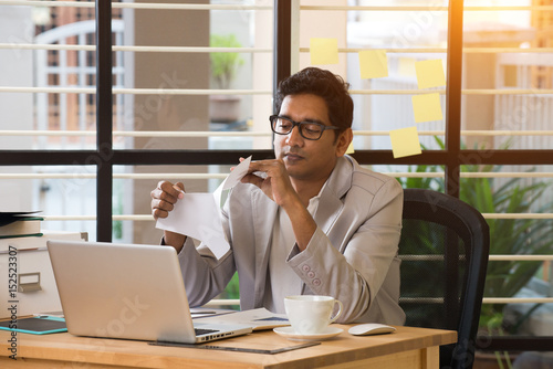 indian male typing resignation letter photo