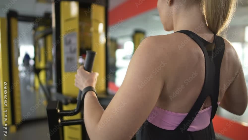 Attractive lady working out in gym, stretching her body and keeping it toned Attractive lady working out in gym, stretching her body and keeping it toned