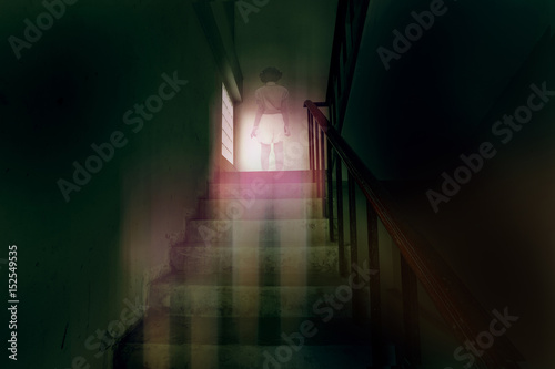 Photography ghost little girl appears on stairs in haunted house, child is confined to death