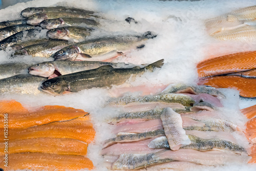 Fresh fish fillets on ice for sale at a market